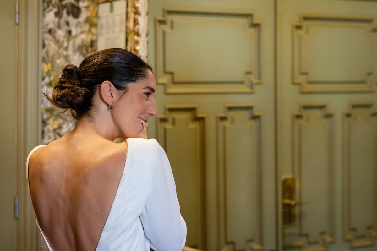 Model in a backless satin date-night dress