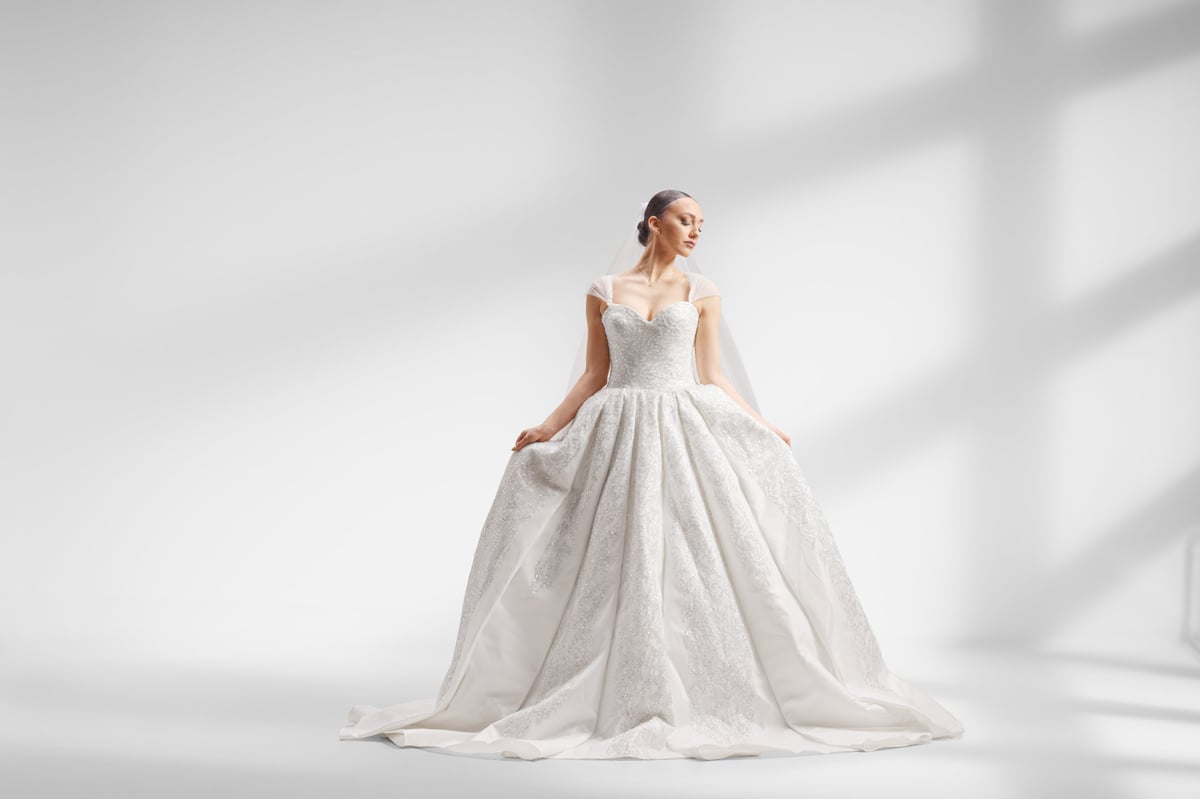 Model in a luxury white gown, studio shadows